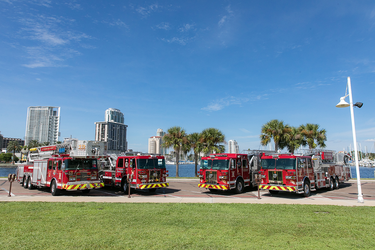 4 fire trucks in front of waterfront